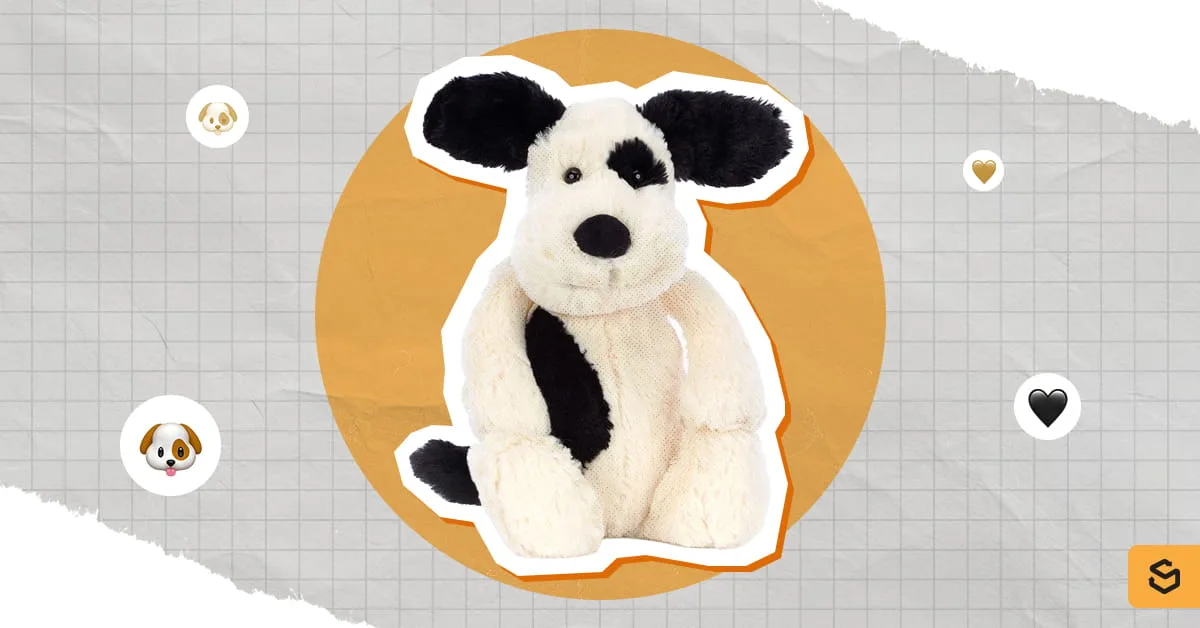A sitting Bashful Black and Cream Puppy