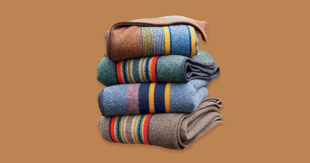 Pendleton blankets stack vertically with dark mocha background