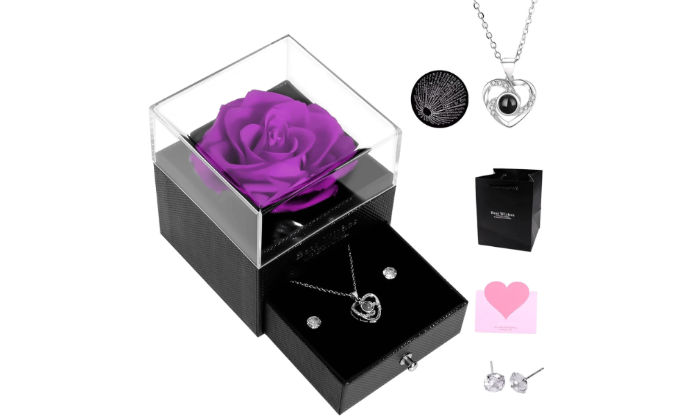 A purple rose in a box with jewellery.