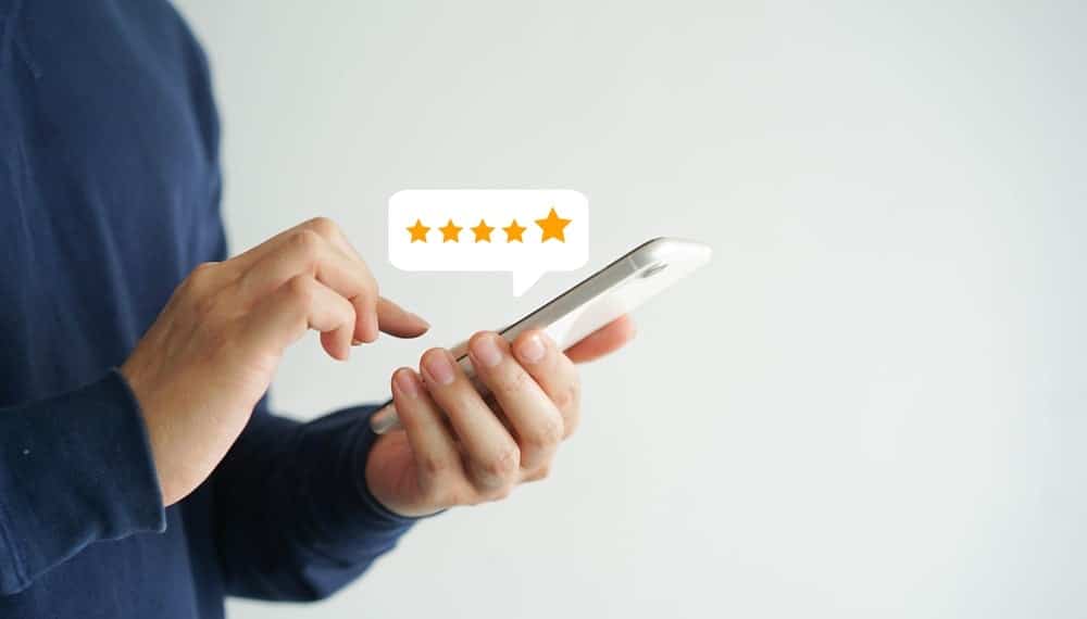 A person giving a 5-star rating using a mobile phone.