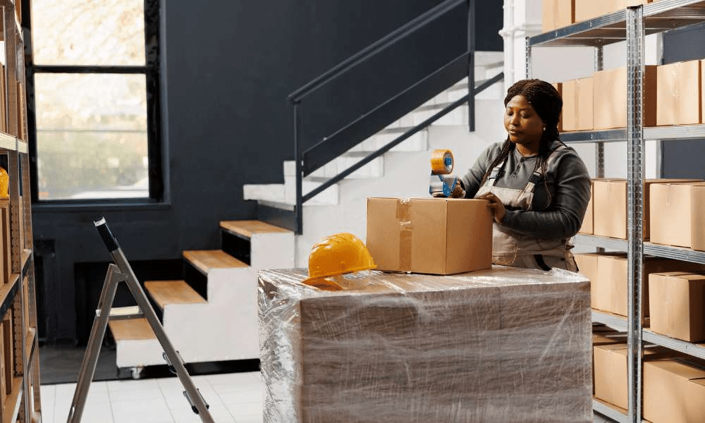 A woman packing a package.