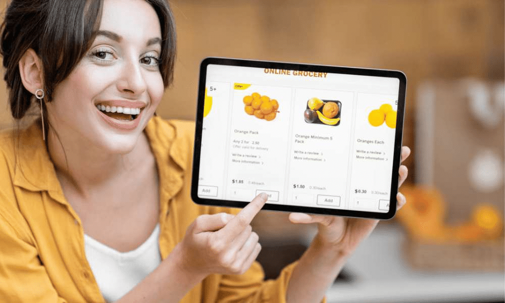 Person shopping on a tablet with an online grocery interface.