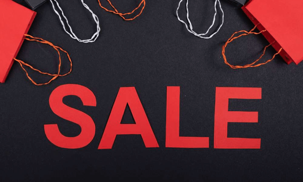 Red "SALE" text with corner of shopping bags above.