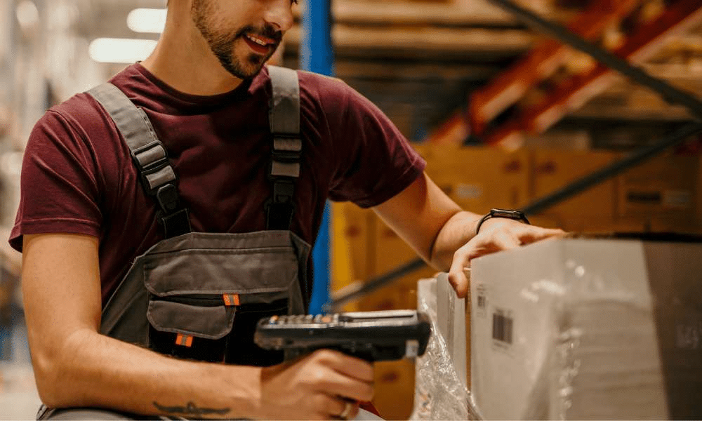 Worker with barcode scanner in a warehouse.