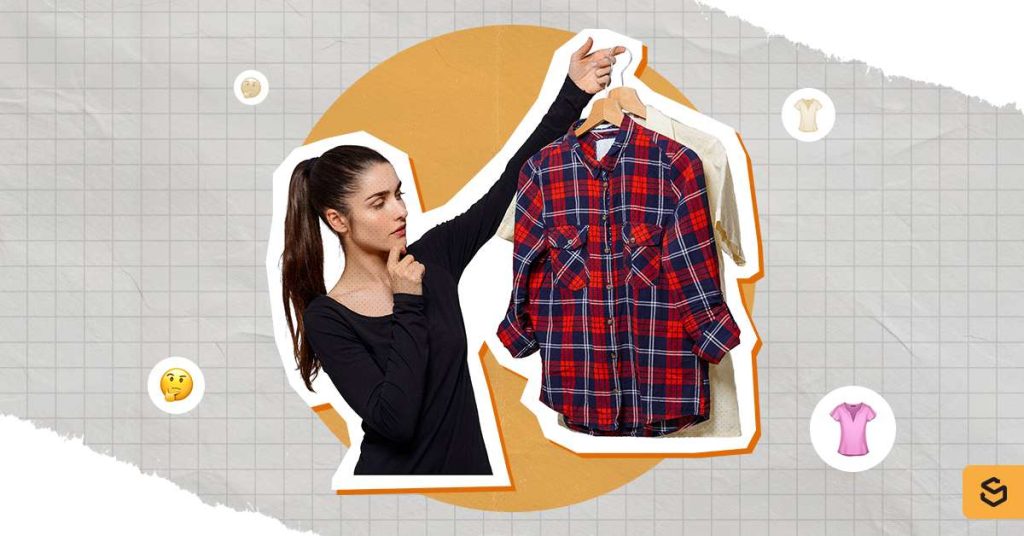 A woman choosing from two clothes.
