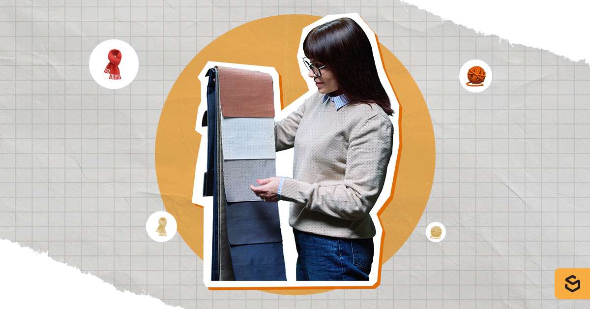 A person choosing a fabric.